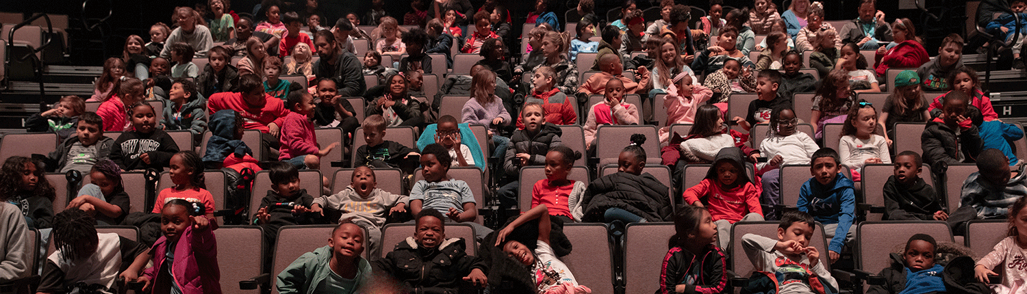 Students sitting in seats waiting for a show to begin at Starlight.