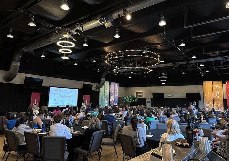 A group of people seated at a luncheon.