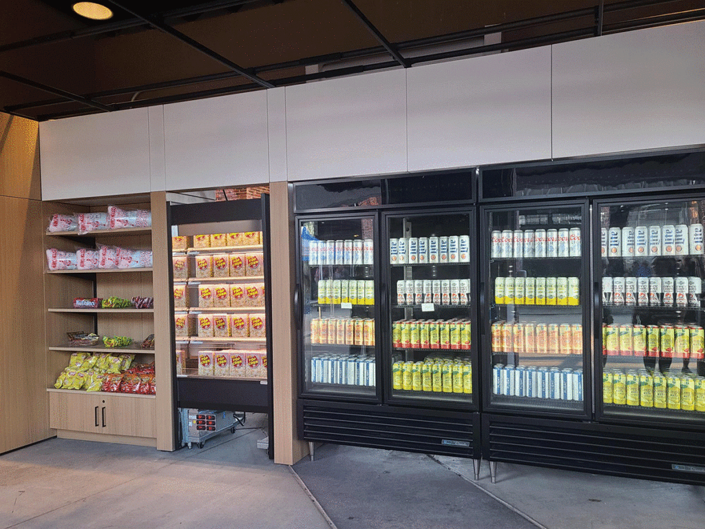 Cases with drinks and shelves with snacks in the Starlight Express Market.